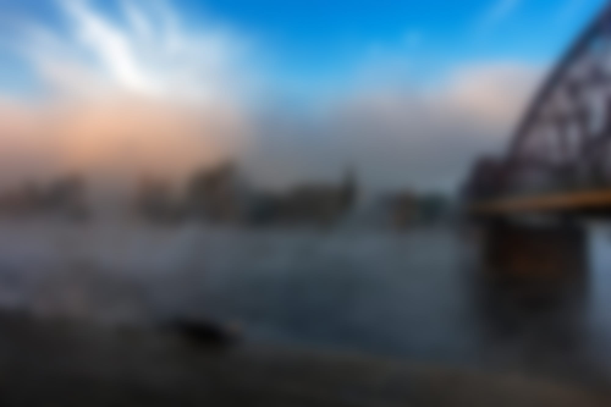 blurry photo of a bridge on a lake