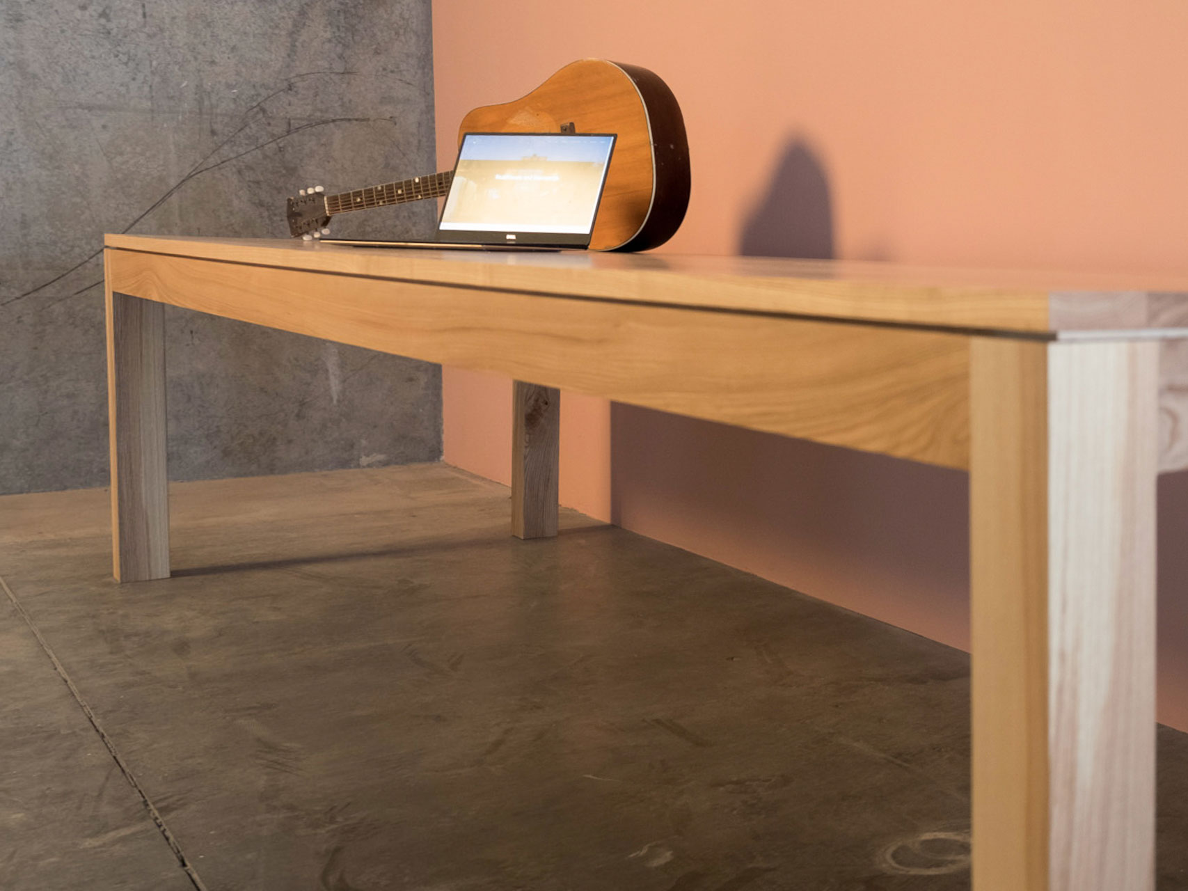 conference table with laptop and guitar